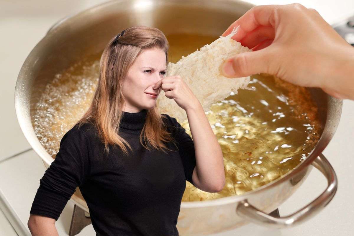 donna che si tappa il naso a causa del cattivo odore di fritto